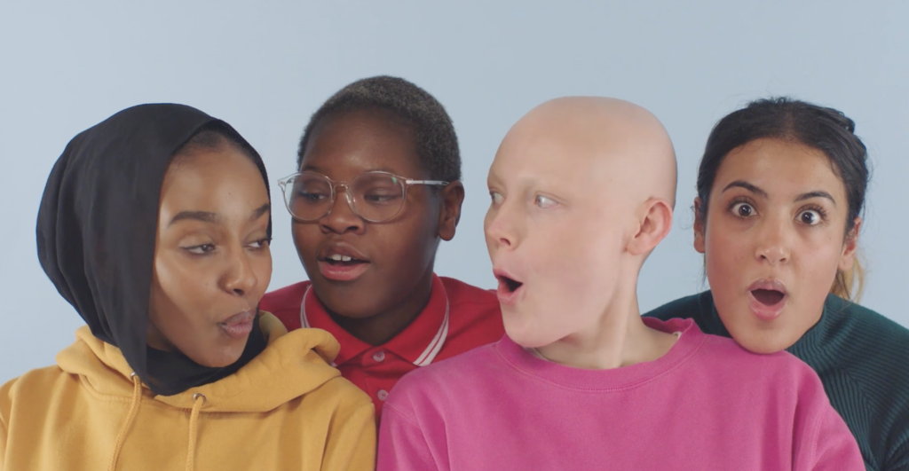 Four people react with surprise and curiosity, representing different ethnicities, identities and appearances against a light blue background.