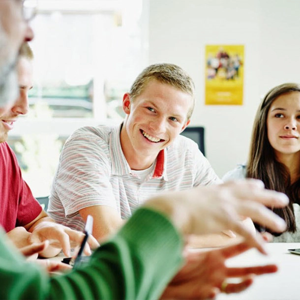 Students participating in a group discussion, representing student wellbeing, connection and support at school.